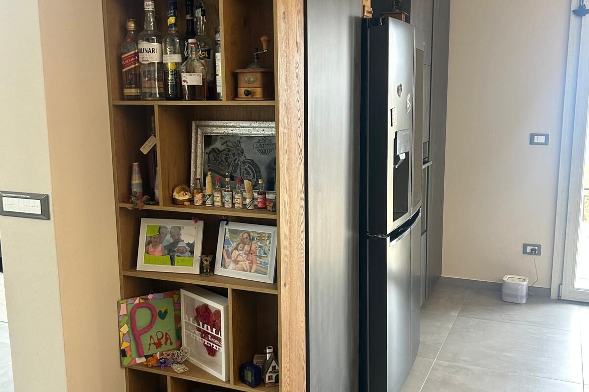 cucina moderna con isola snack e tavolo in legno massello